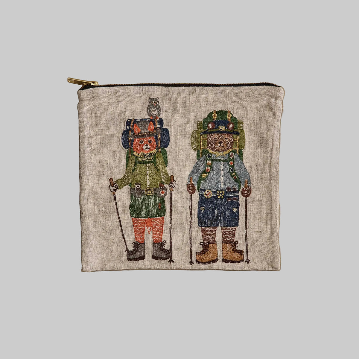 Coral and Tusk's embroidered linen "Explorers" pouch featuring a design of fox and bear friends prepared for an outdoor adventure