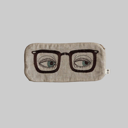 Coral and Tusk's "Glasses" pouch embroidered with a black glasses design and blue eyes