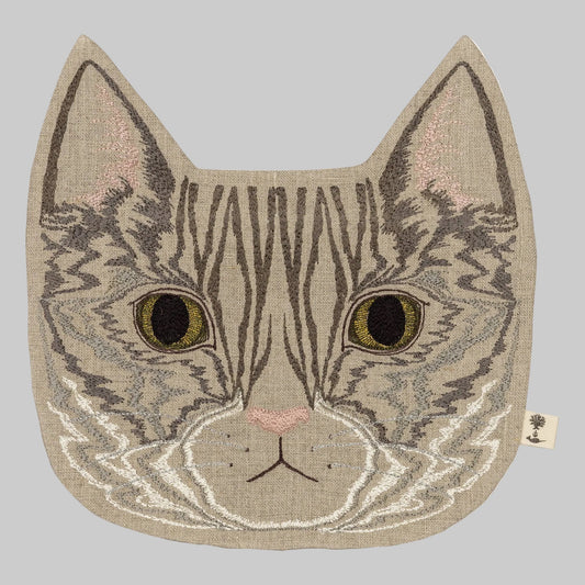 Coral and Tusk’s “Tabby Cat” embroidered linen pouch featuring a gray striped cat with bright green eyes