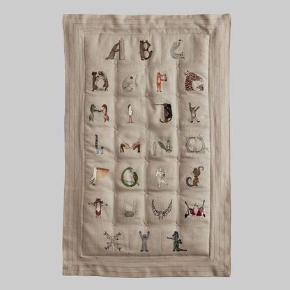 Coral and Tusk's embroidered linen quilt for children or a nursery. Feature alphabet designs with animals playfully representing each letter. 
