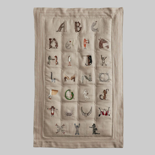 Coral and Tusk's embroidered linen quilt for children or a nursery. Feature alphabet designs with animals playfully representing each letter. 