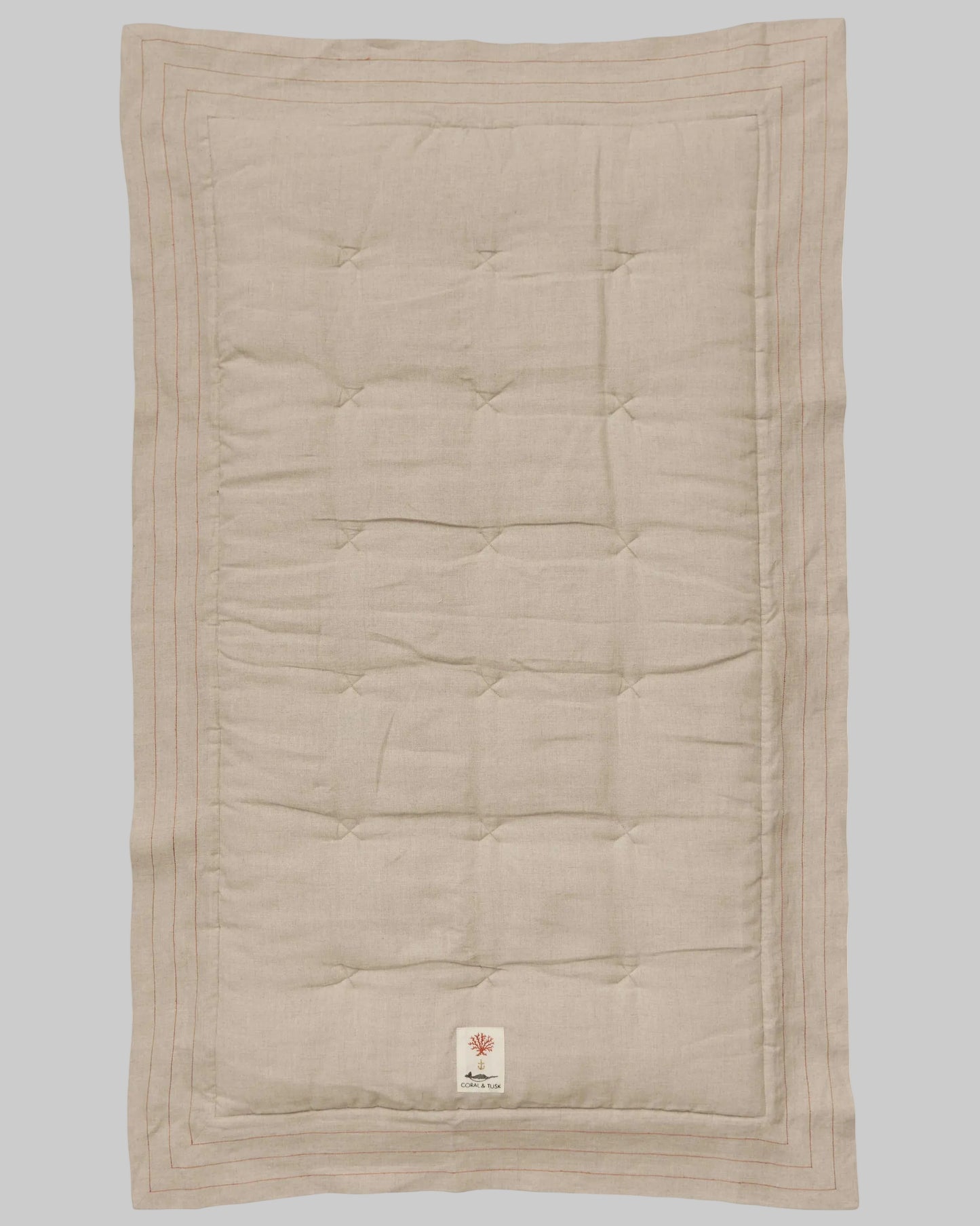 Coral and Tusk's embroidered linen quilt for children or a nursery. Feature alphabet designs with animals playfully representing each letter.