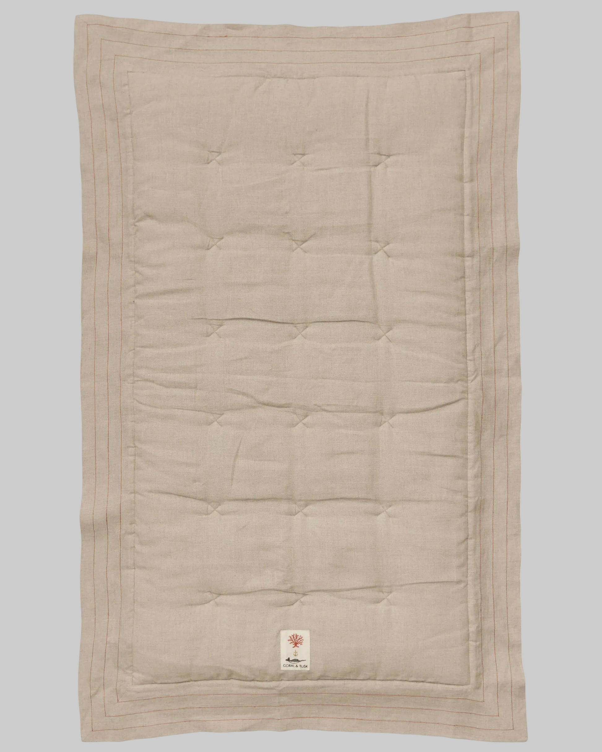 Coral and Tusk's embroidered linen quilt for children or a nursery. Feature alphabet designs with animals playfully representing each letter.