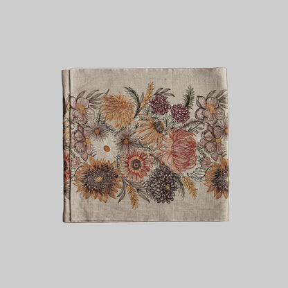 Coral and Tusk’s “Autumn Blossoms” embroidered linen table runner featuring earth tone florals and wheat stems