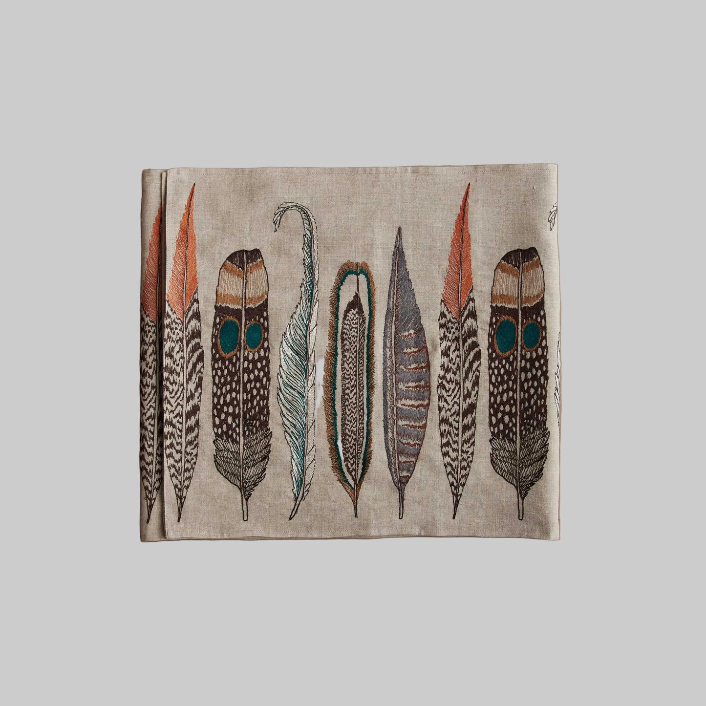 Coral and Tusk’s “Large Feathers” embroidered linen table runner featuring found feathers from a variety of birds