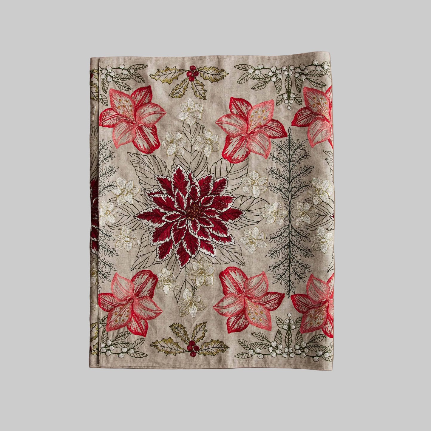 Coral and Tusk’s “Christmas Flowers” table runner featuring bold red and white florals