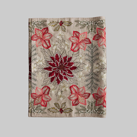 Coral and Tusk’s “Christmas Flowers” table runner featuring bold red and white florals