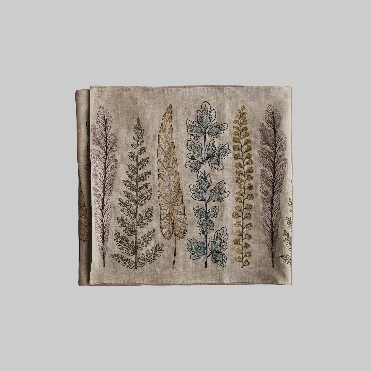 Coral and Tusk’s “Plants” embroidered linen table runner featuring a variety of green stems and sprigs