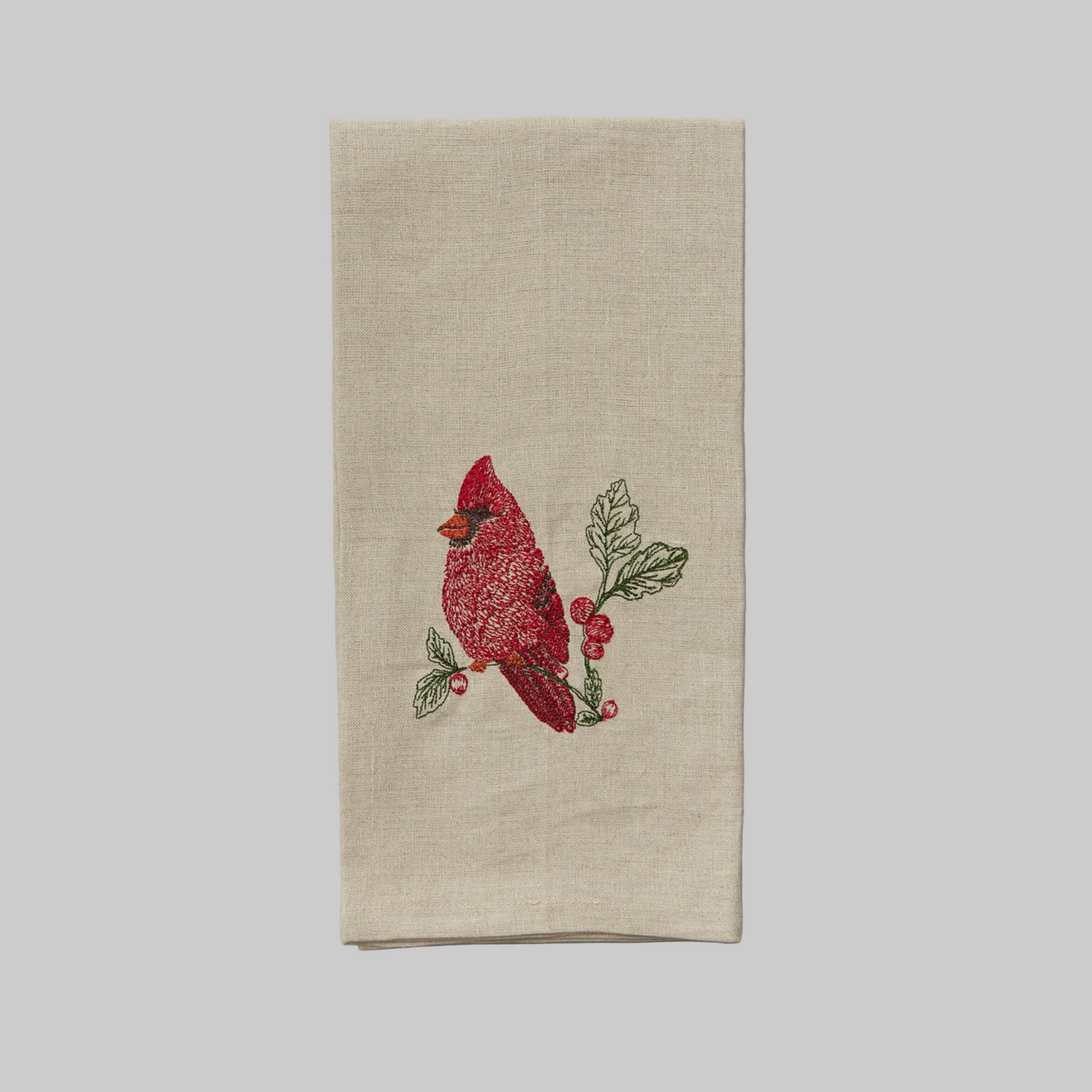 Coral and Tusk's "Red Cardinal" tea towel featuring a red cardinal on a holly branch
