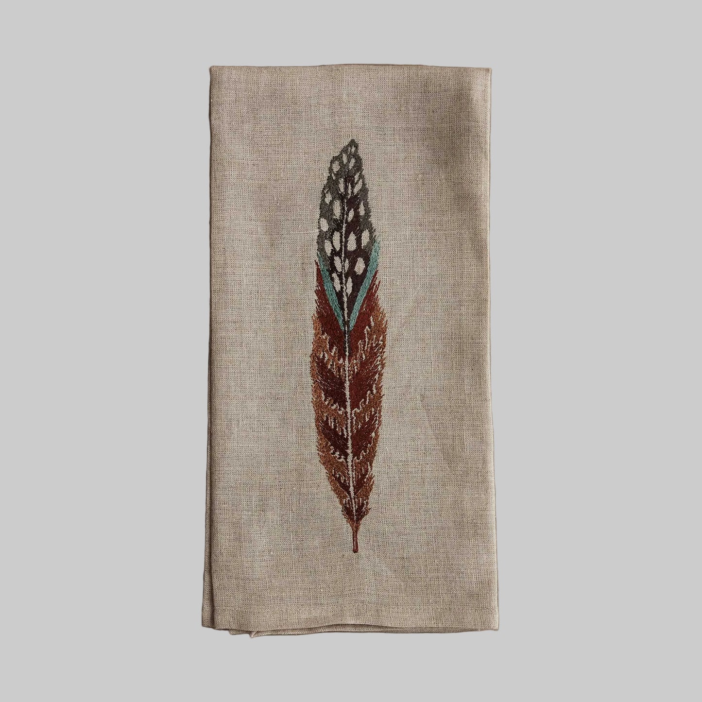 Coral and Tusk’s “Fowl Feather” embroidered linen tea towel featuring