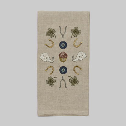 Coral and Tusk’s “Good Luck” embroidered linen tea towel featuring lucky charms