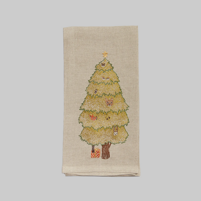 Coral and Tusk's "Peek a Tree" embroidered linen tea towel featuring woodland creatures peeking through an evergreen Christmas tree
