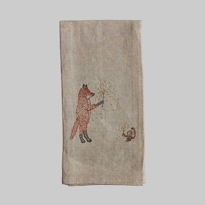 Coral and Tusk’s “Sparklers” embroidered linen tea towel featuring a fox and monkey holding sparklers