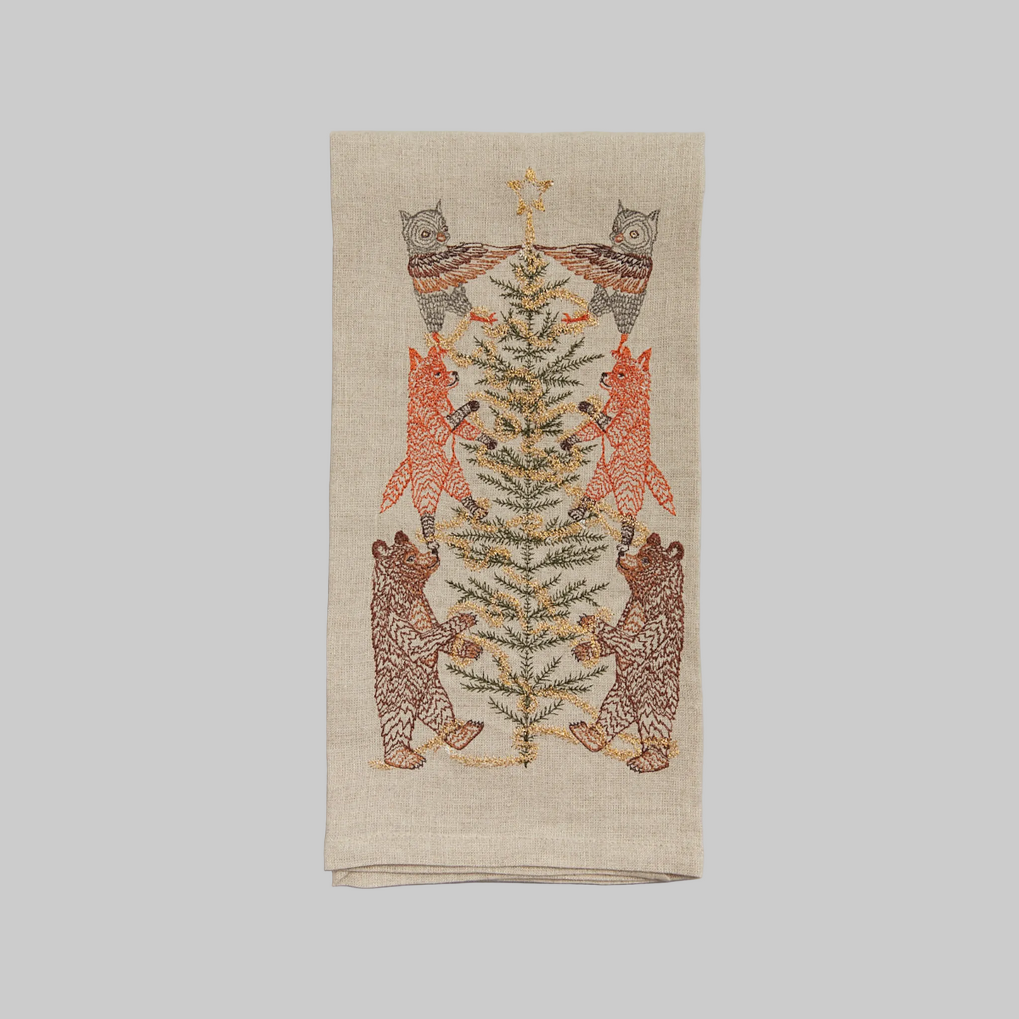 Coral and Tusk's "Tinsel Tree" embroidered linen tea towel featuring woodland animals decorating a Christmas tree with tinsel