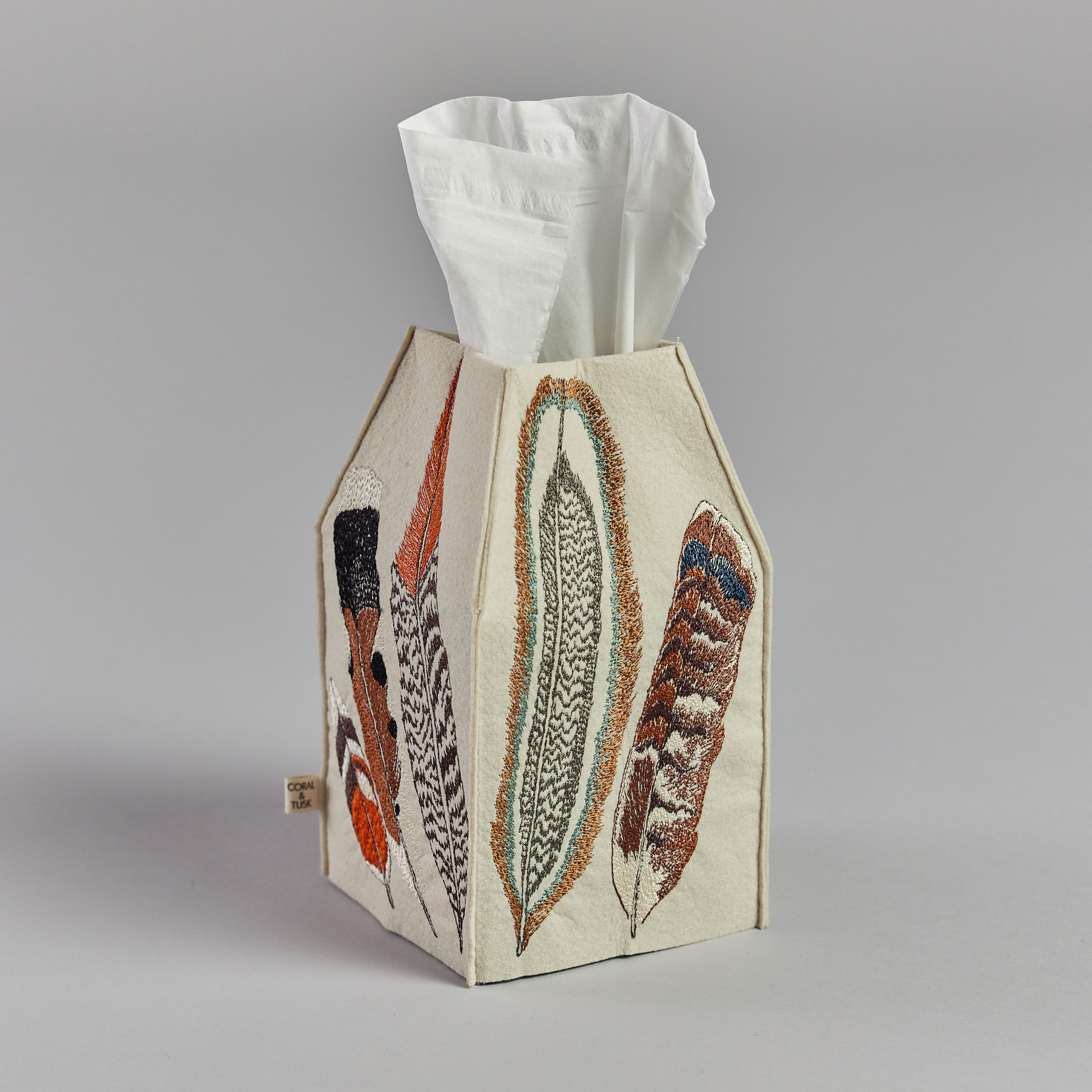 Coral and Tusk's "Feathers" tissue box cover made of felt and embroidered with a varied feather design