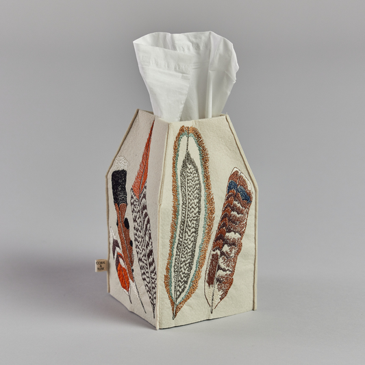 Coral and Tusk's "Feathers" tissue box cover made of felt and embroidered with a varied feather design