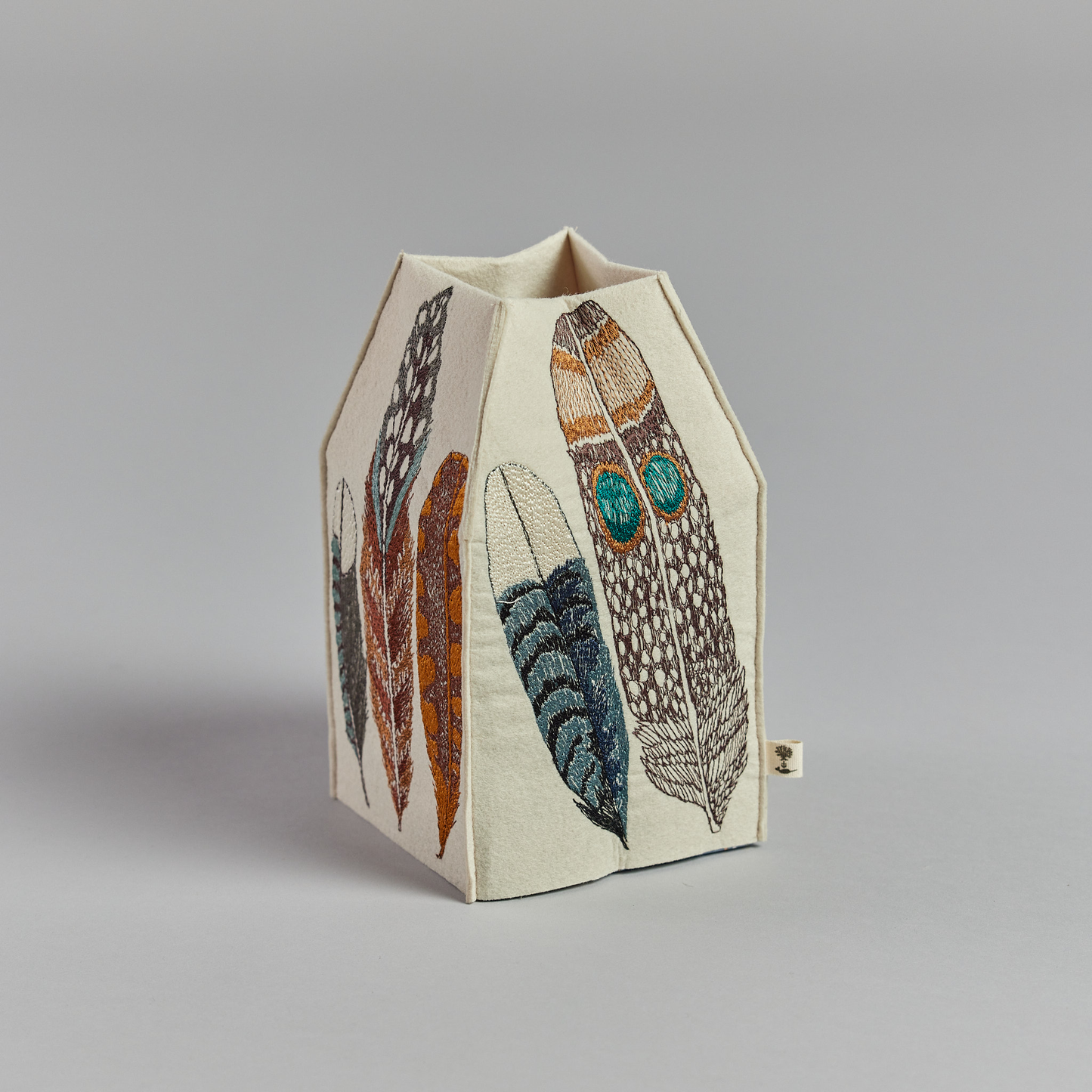 Coral and Tusk's "Feathers" tissue box cover made of felt and embroidered with a varied feather design