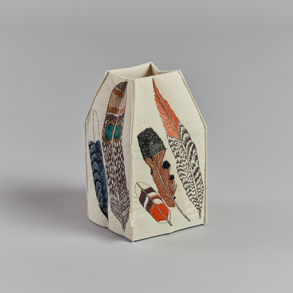 Coral and Tusk's "Feathers" tissue box cover made of felt and embroidered with a varied feather design