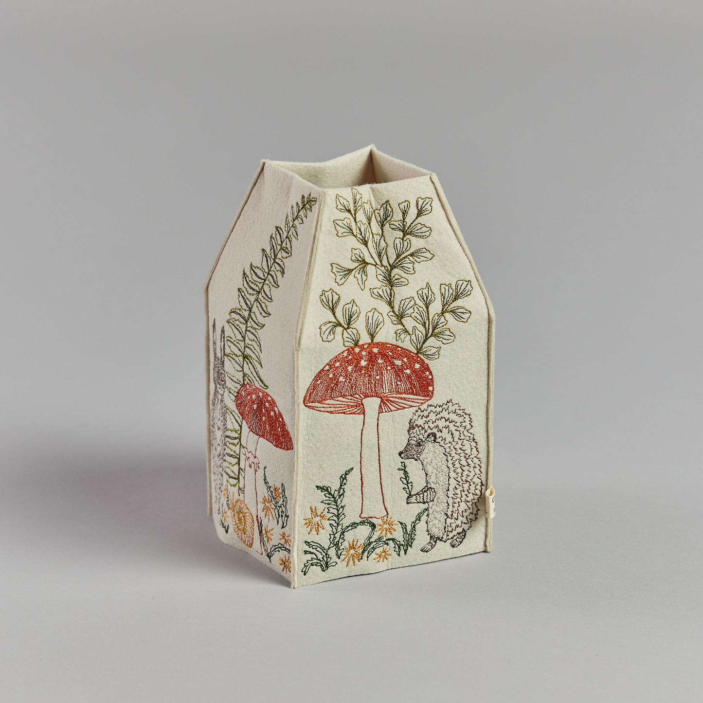 Coral and Tusk's "Mushrooms and Ferns" tissue box cover made of felt and embroidered with animal, mushroom, and fern designs