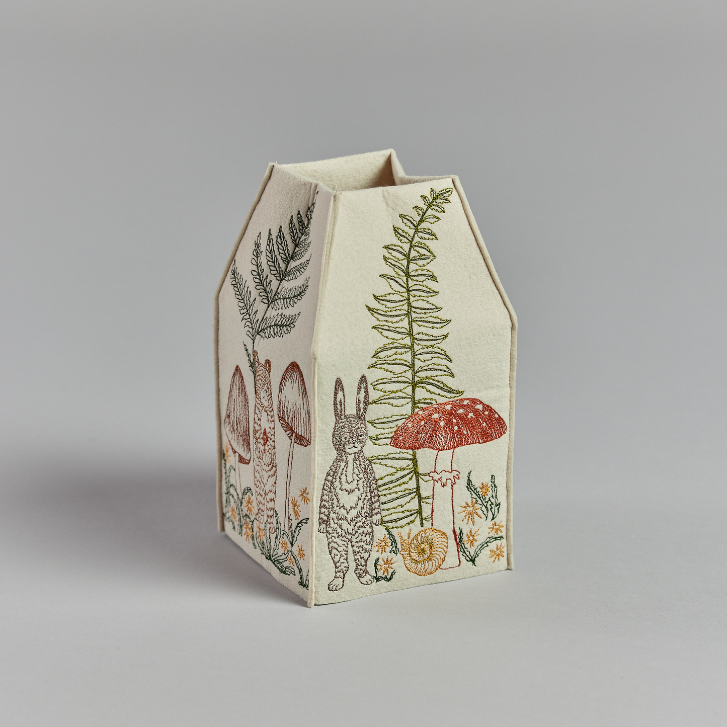 Coral and Tusk's "Mushrooms and Ferns" tissue box cover made of felt and embroidered with animal, mushroom, and fern designs