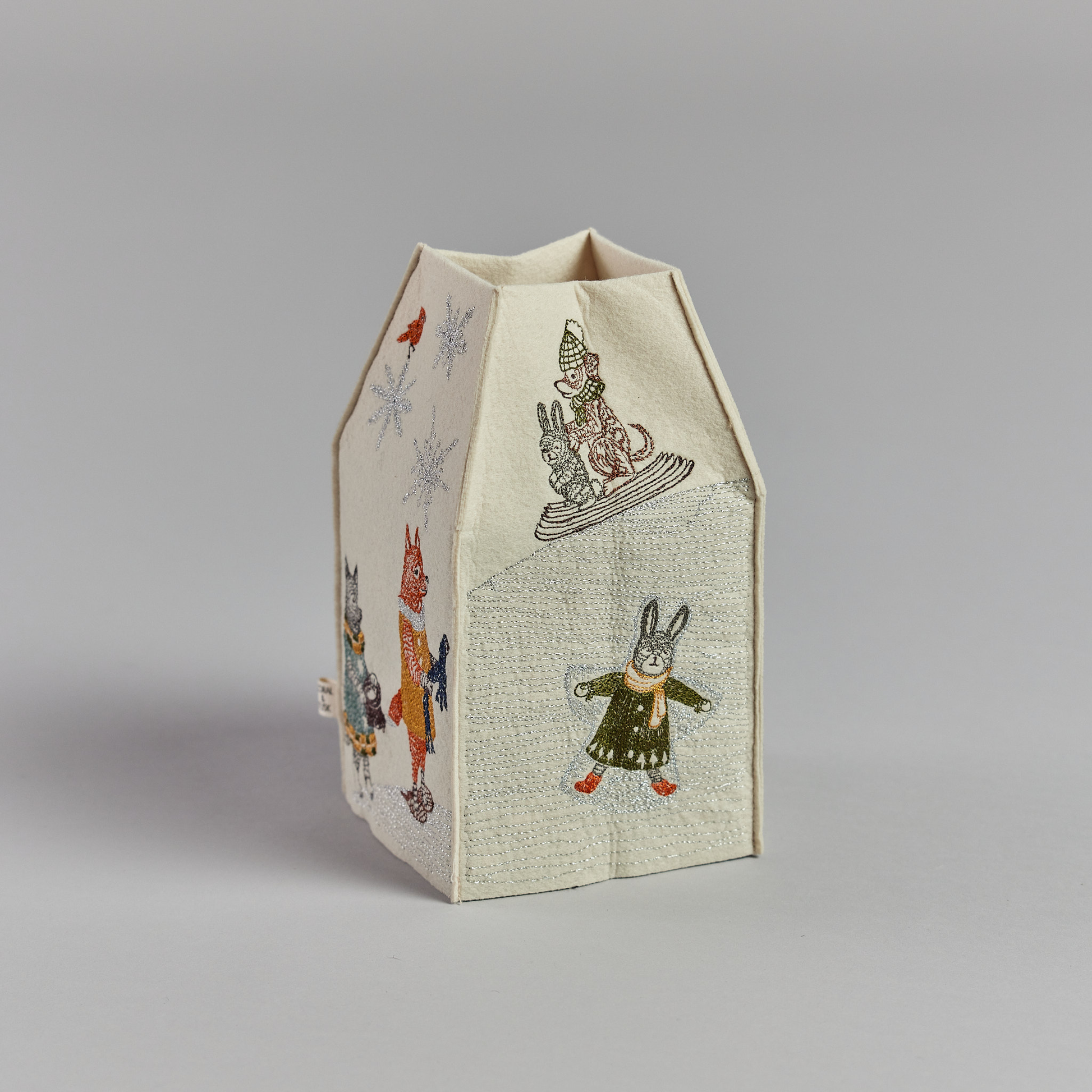 Coral and Tusk's "Snow Day" tissue box cover made of felt and embroidered with animals playing in the snow design