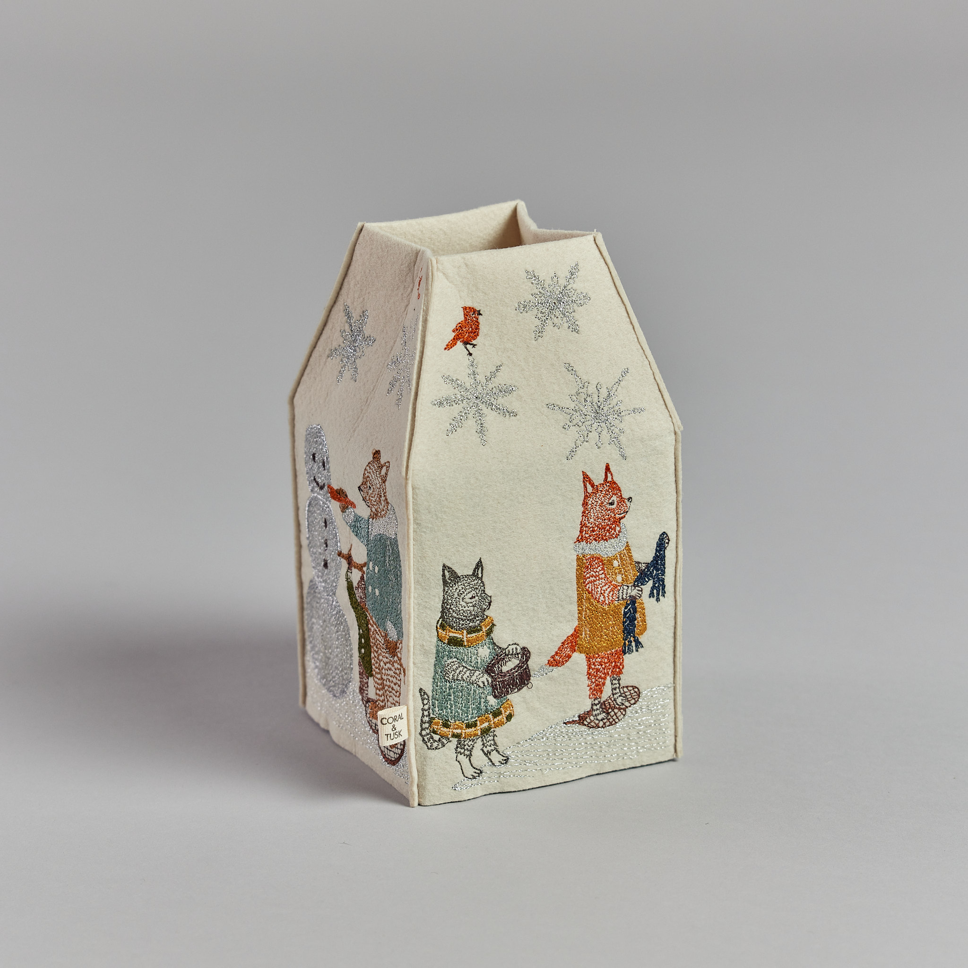 Coral and Tusk's "Snow Day" tissue box cover made of felt and embroidered with animals playing in the snow design