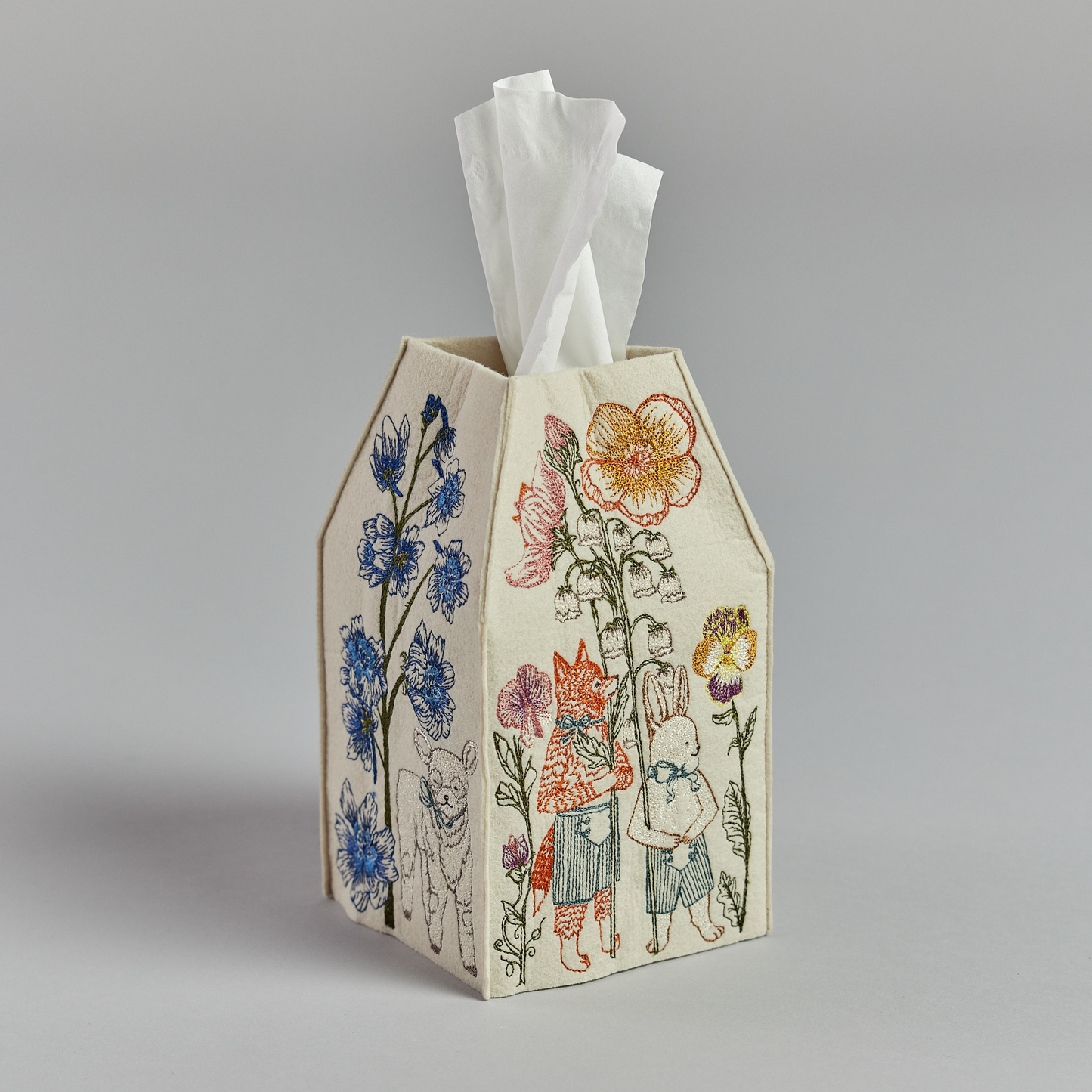 Coral and Tusk's "Spring Parade" tissue box cover made of felt and embroidered with animal and floral designs