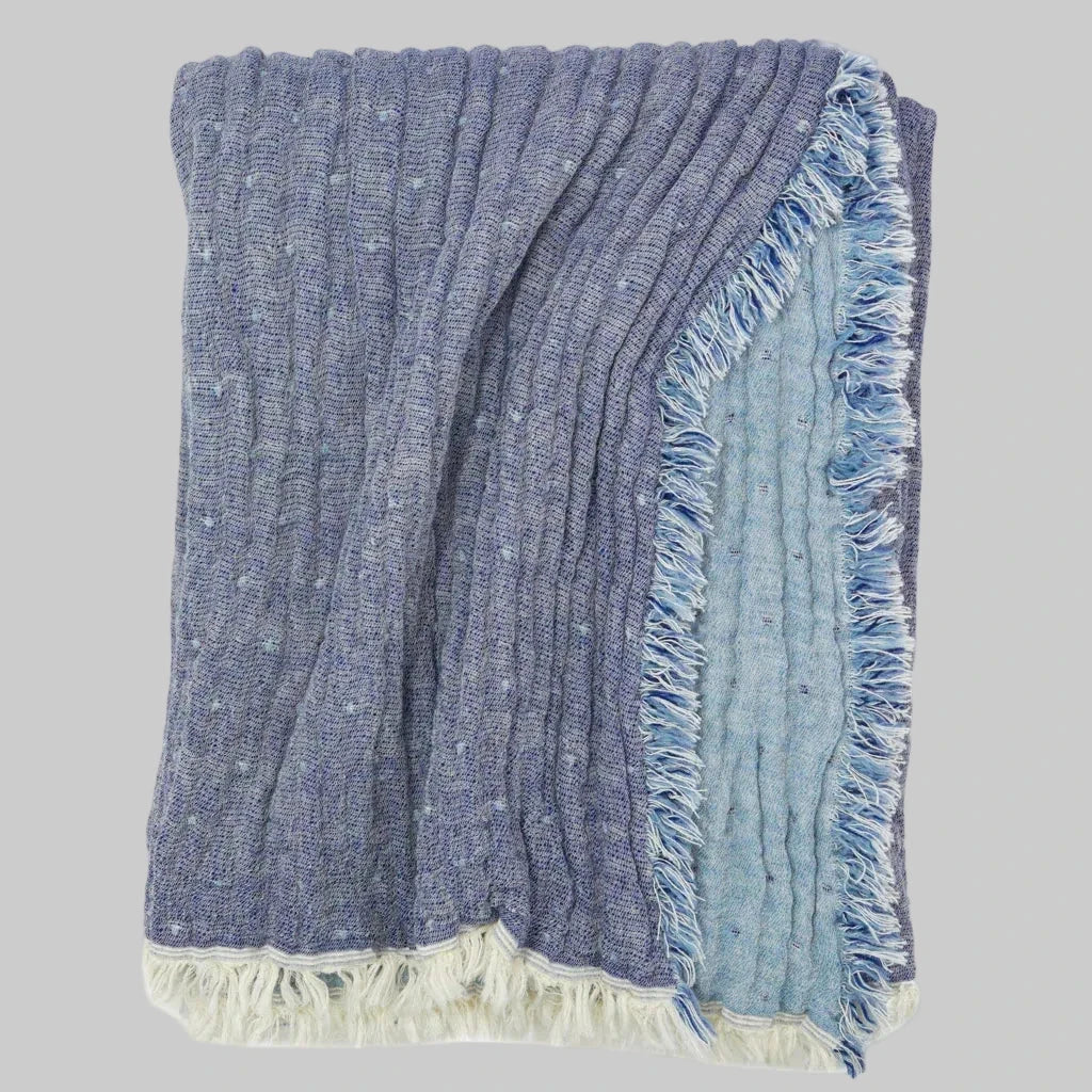 Johanna Howard Home's woven Cozi Throw blanket in blue, made of cotton, wool, and nylon.