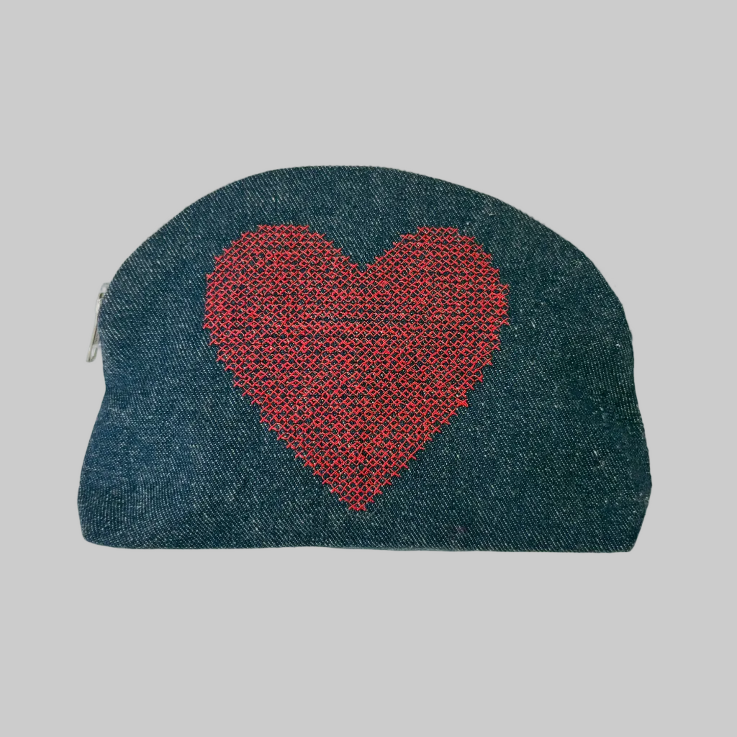 K. Studio’s denim pouches with embroidered red heart design and metal zipper