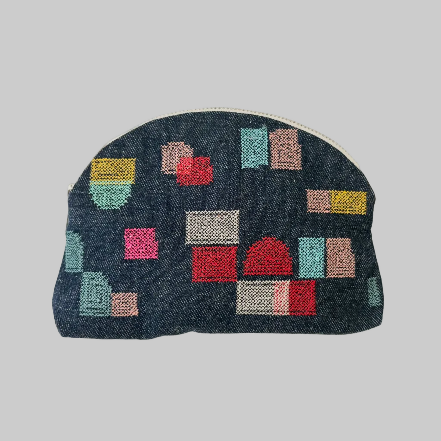 K. Studio’s denim pouches with colorful embroidered swatch designs and metal zipper