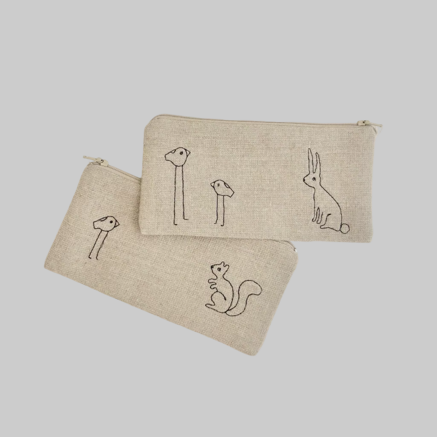 K. Studio’s flax pouches with embroidered bird, squirrel, and rabbit designs and metal zippers