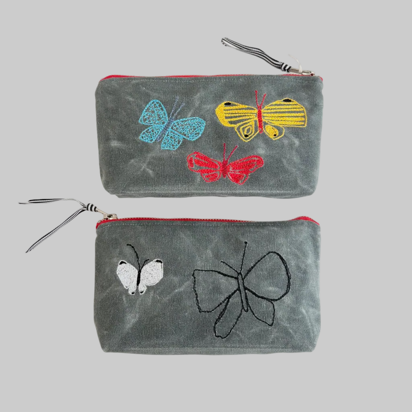 K. Studio’s waxed canvas pouches with embroidered butterfly designs and metal zippers