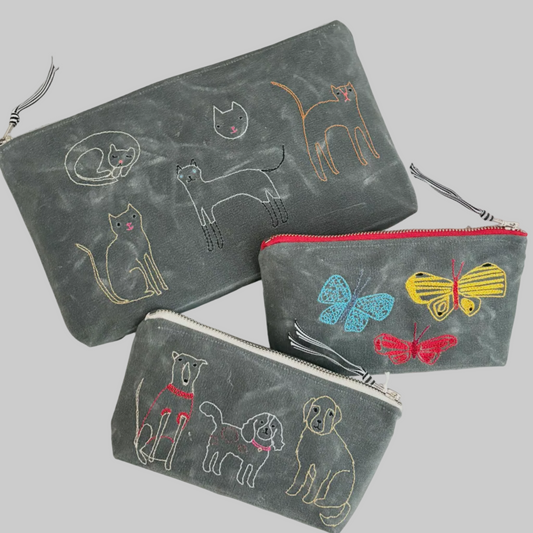 K. Studio’s waxed canvas pouches with playful embroidered designs with metal zippers
