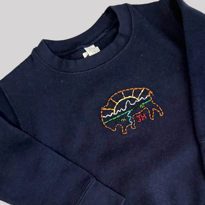 Roam Wild Good’s hand-embroidered kids sweatshirt in navy with bison and Teton mountain design inspired by Jackson Hole, Wyoming