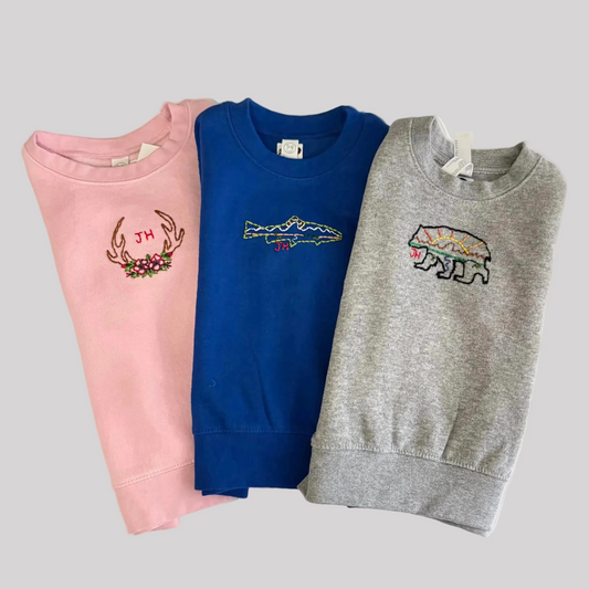 Roam Wild Good’s hand-embroidered kids sweatshirts featuring designs inspired by Jackson Hole, Wyoming