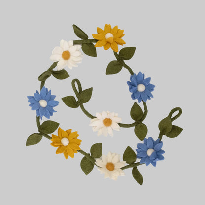 Wool-felted garland from The Winding Road featuring blue, yellow, and white daisies, use for house decor or kids room