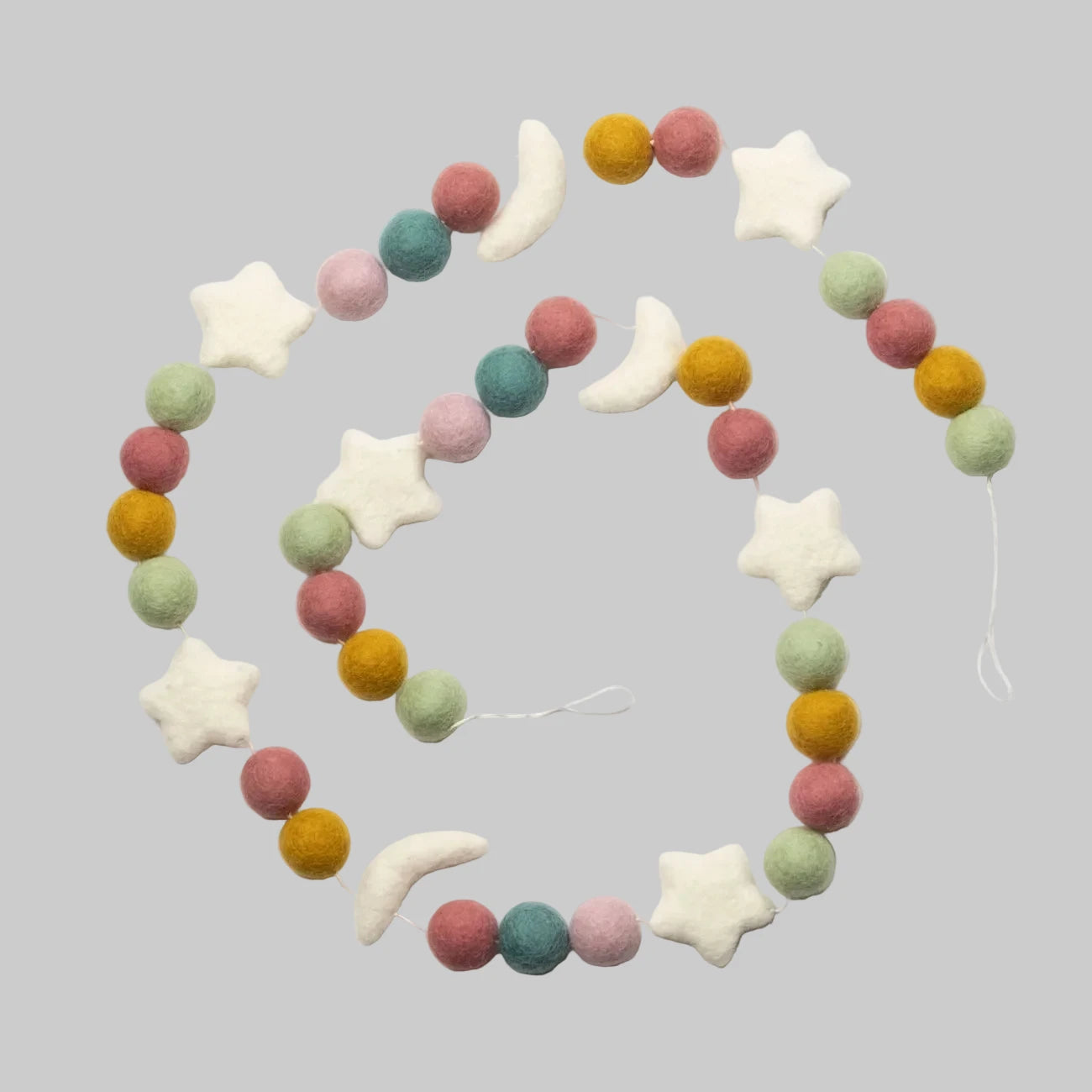 Wool-felted garland from The Winding Road featuring pastel beads and white moons and stars, use for house decor or kids room