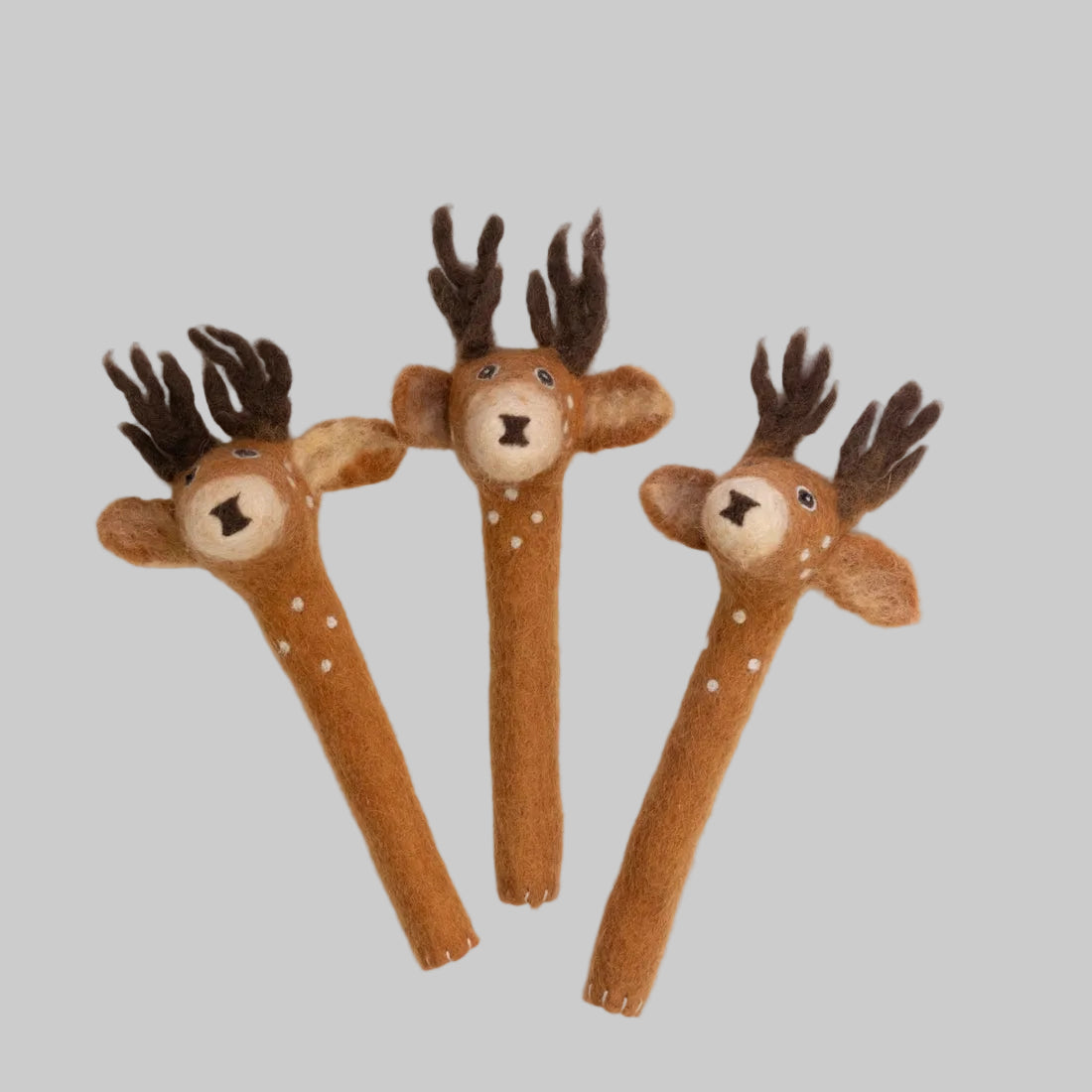 The Winding Road's felted pencil toppers designed to look like brown, white-spotted deer. Fair trade and made of 100% wool.