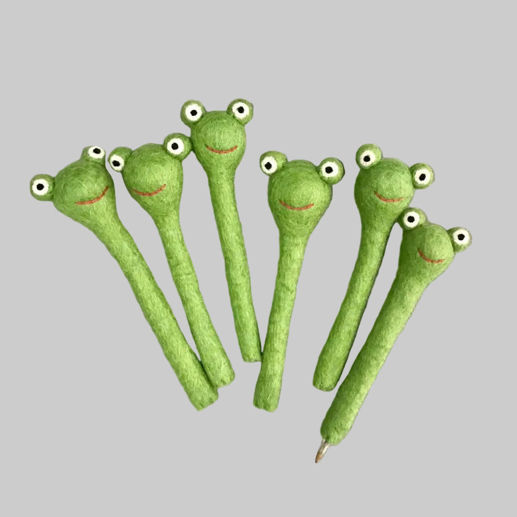 The Winding Road's felted pencil toppers designed to look like green frogs. Fair trade and made of 100% wool.