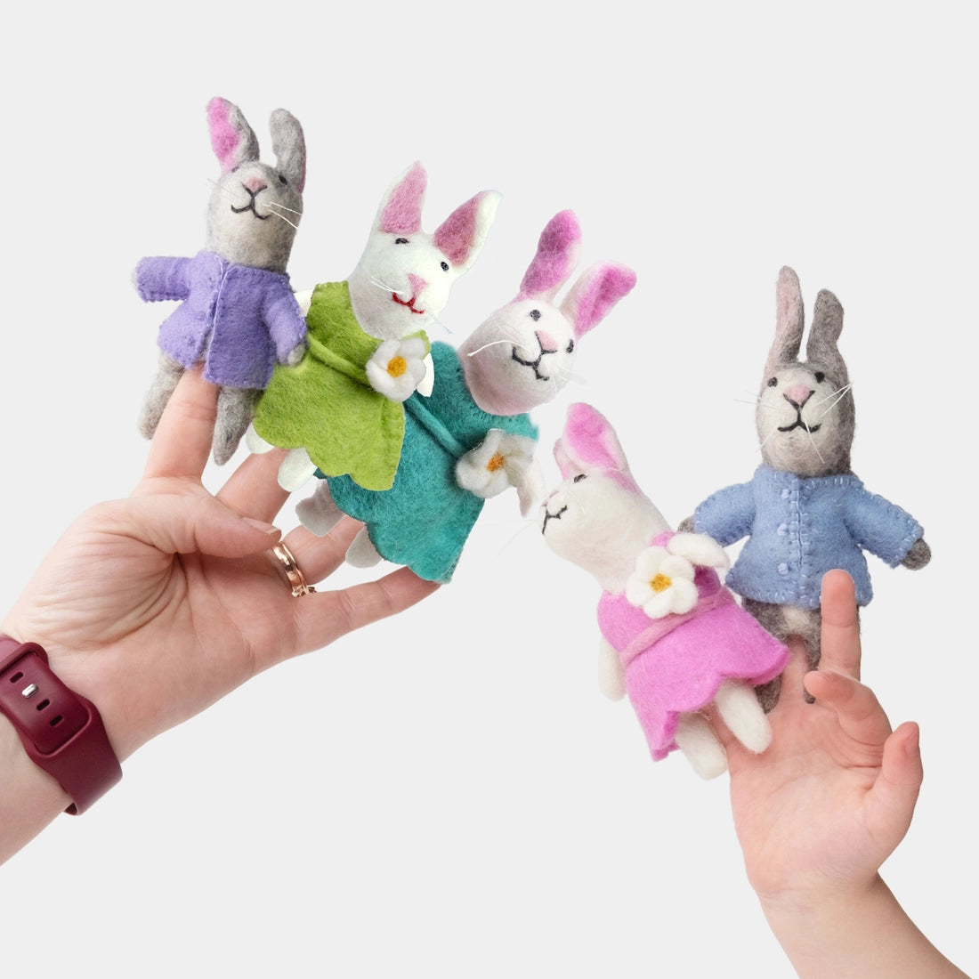 The Winding Road’s wool-felted bunny finger puppets wearing clothing
