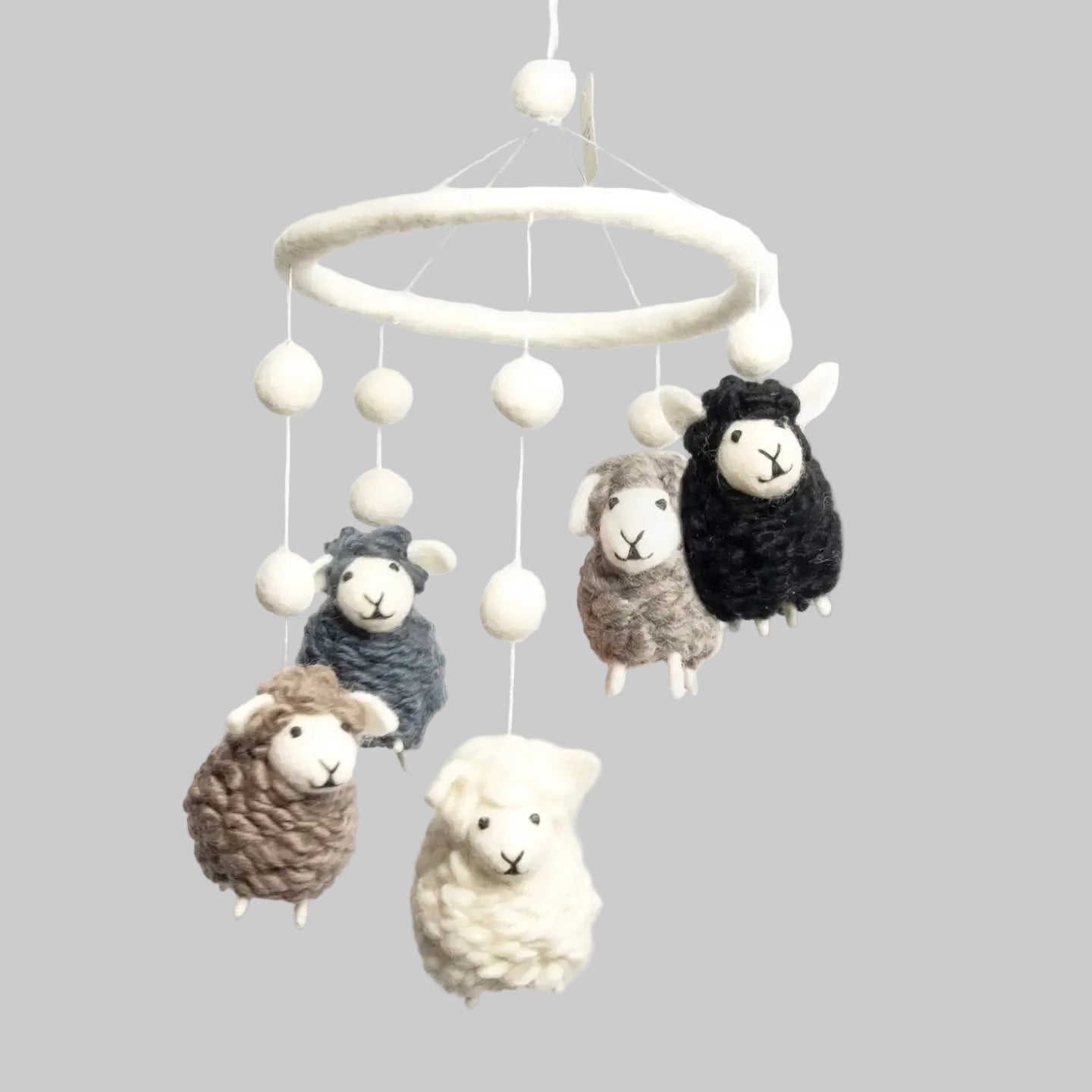 The Winding Road’s wool-felted baby mobile with black, white, and gray sheep, handmade and fair trade 