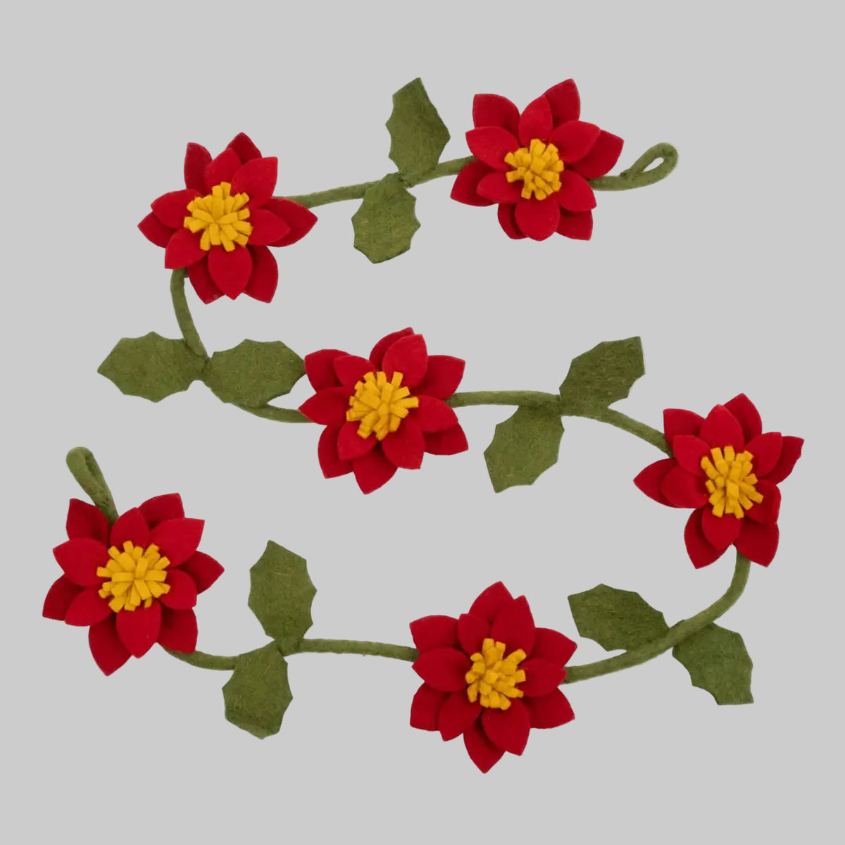 The Winding Road's wool-felted holiday garland featuring green sprigs and red poinsettias. Handmade and fair trade.