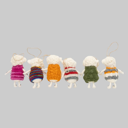 The Winding Road's wool-felted ornaments featuring white sheep wearing colorful sweaters. Handmade and fair trade.