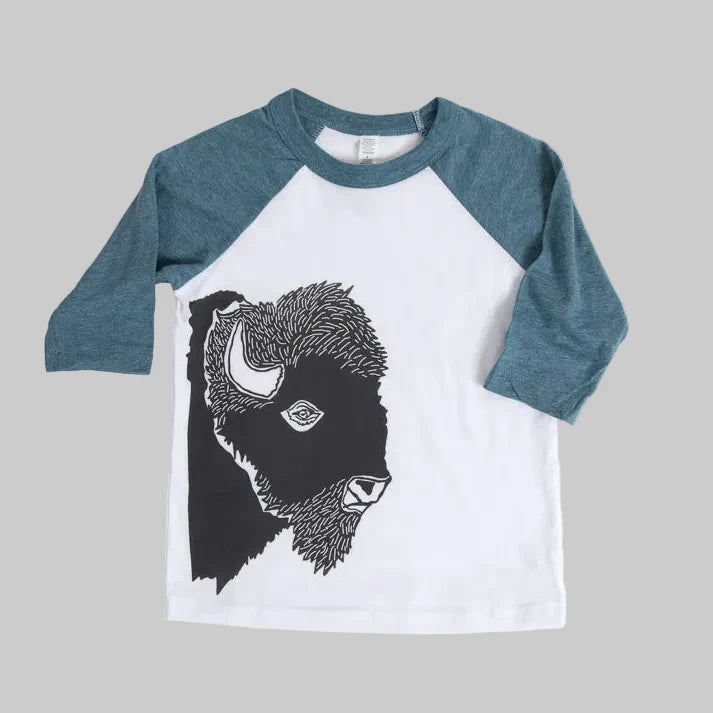 Bird and Buffalo’s kids baseball tee with blue sleeves and a bison design, locally made in Jackson Hole, WY
