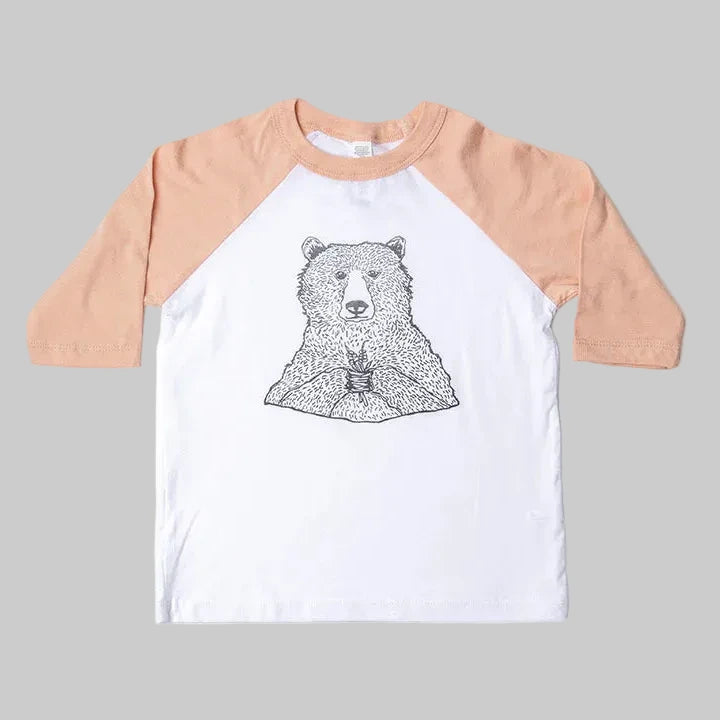 Bird and Buffalo’s kids baseball tee with pink sleeves and a bear holding flowers design, locally made in Jackson Hole, WY