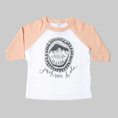 Bird and Buffalo’s kids baseball tee with pink sleeves and a mountain logo design, locally made in Jackson Hole, WY