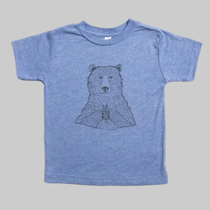 Bird and Buffalo’s kid’s t-shirt in blue with a bear holding flowers design, locally made in Jackson Hole, WY