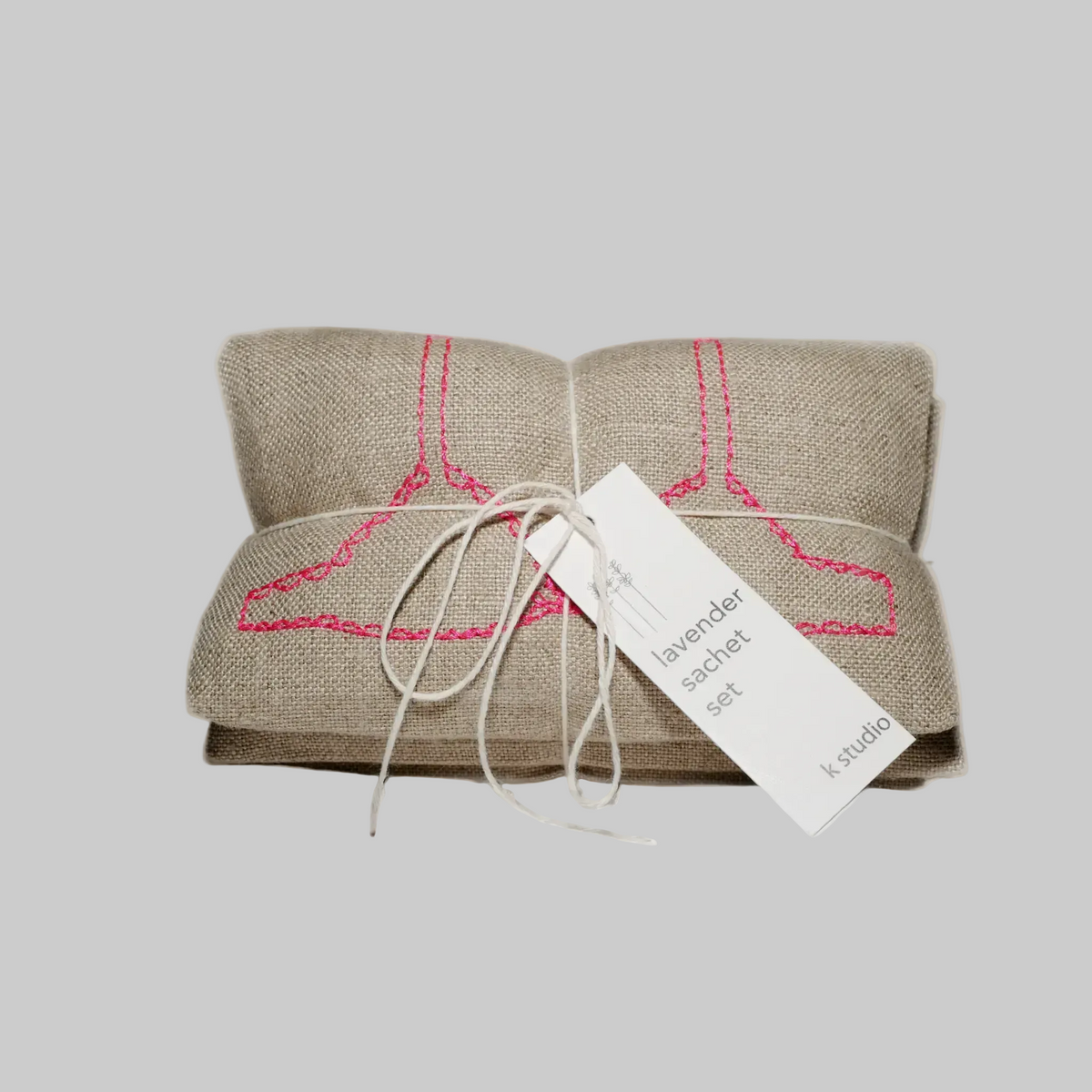 K. Studio’s lavender sachets embroidered with bright pink bra, underwear, and sock designs