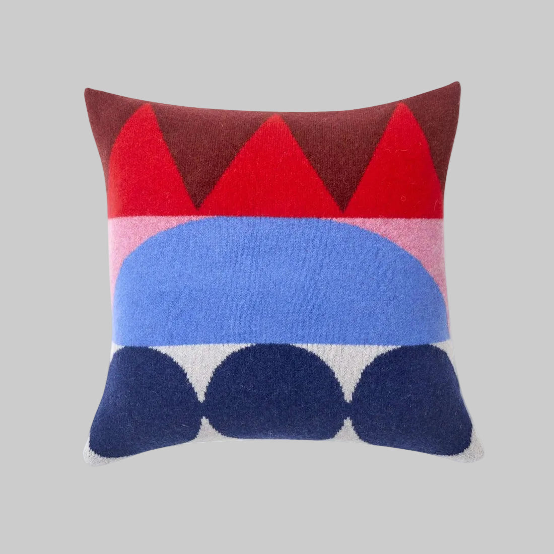 Donna Wilson's "Totem" square throw pillow featuring brightly colored geometric designs